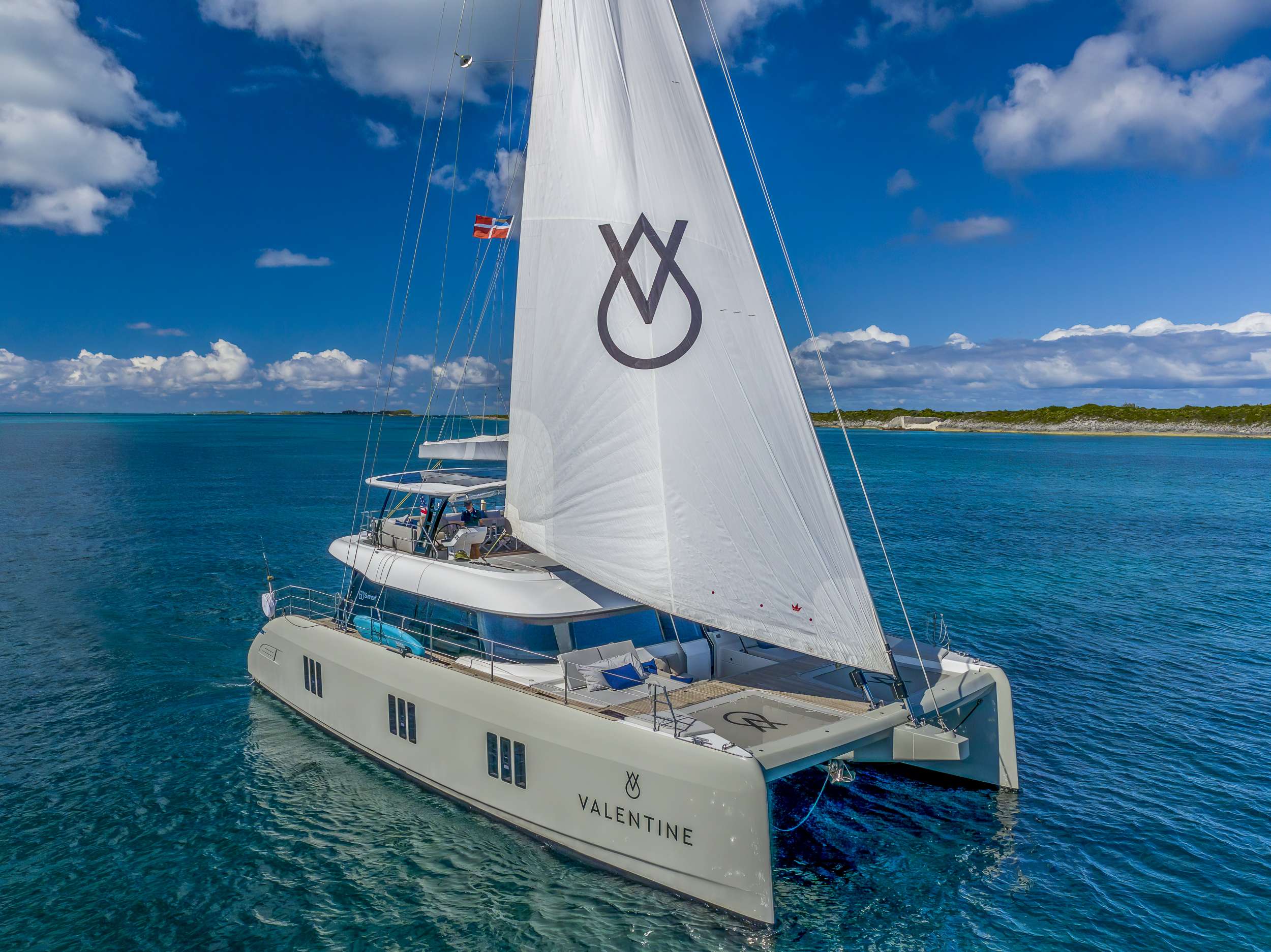 VALENTINE sailing past a low island